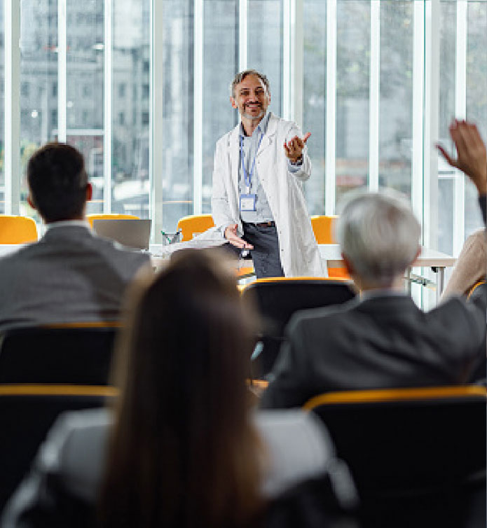 HCI-board-certified-home Doctor speaking to a room of people