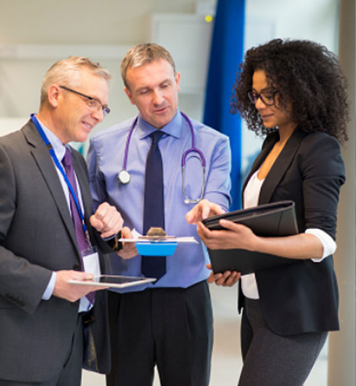 HCI-managment-home HCI group of people standing together talking about business matters